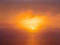 Sonnenaufgang mit Farbspektakel an Wolken und Wasser des Chiemsees